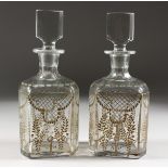 A GOOD PAIR OF BACARAT GILDED DECANTERS AND STOPPERS.