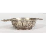 A CONTINENTAL SILVER TWO-HANDLED BOWL, the handles as Heraldic crests. 4.5ins diameter.