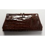 A BROWN CROCODILE LEATHER HANDBAG.