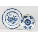 AN 18TH CENTURY DELFT PLATE, painted with a central flower on a table under two borders, and a