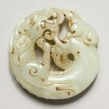 A CHINESE ARCHAIC STYLE CARVED JADE ROUNDEL. 2ins diameter.