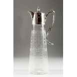 A HAND ENGRAVED GLASS CLARET JUG with plated mounts and handle.