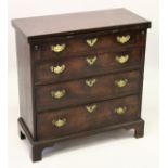 A GOOD GEORGE III MAHOGANY BACHELORS CHEST, with folding top, four graduated long drawers with brass