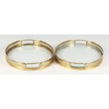 A PAIR OF MODERN BRASS GALLERIED OVAL GLASS TRAYS. 15.25ins x 11.75ins.