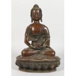 A CHINESE BRONZE BUDDHA SEATED IN THE LOTUS POSITION. 11.5ins high.