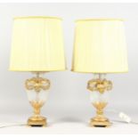 A GOOD PAIR OF ORMOLU AND CUT GLASS VASE SHAPED TABLE LAMPS, with satyr mask handles. 14ins high.