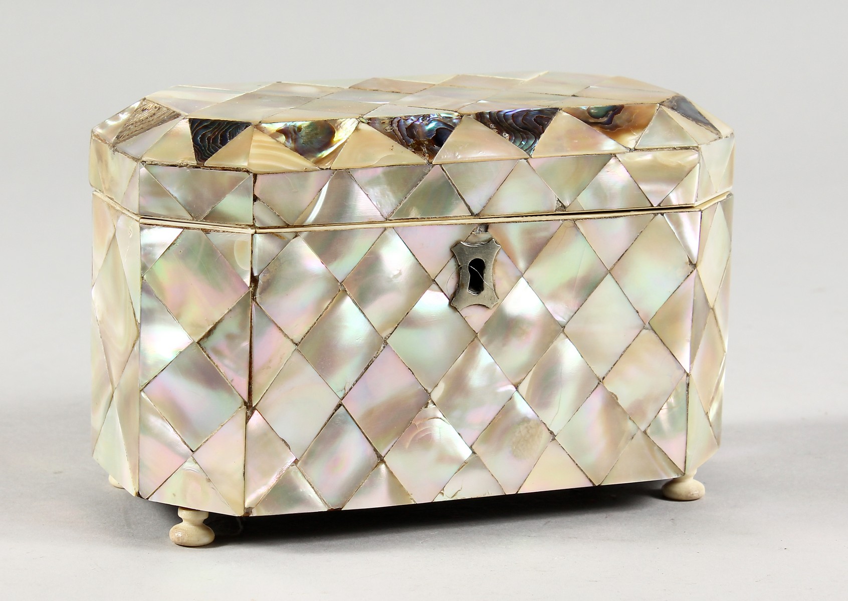 A GOOD MOTHER-OF-PEARL BOX AND COVER on bun feet. 6ins long.
