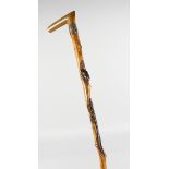 A JAPANESE CARVED RHINO HANDLE WALKING STICK, carved with frogs and alligator. 35ins long.