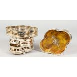 A SET OF FOUR SHAPED FAUX TORTOISESHELL WINE COASTERS.