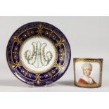 A GOOD SEVRES CUP AND SAUCERS, rich blue ground, portrait of Md. Necker. Mark in blue, Letter K.