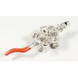 A SILVER AND CORAL RATTLE WITH BELLS. 5.5ins long.
