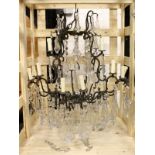 A GOOD CHANDELIER, with twelve bronzed scrolling branches hung with large cut glass drops. 3ft