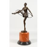 AN ART DECO STYLE BRONZE FIGURE OF THE HOOP DANCER, on a circular marble base. 19ins high.