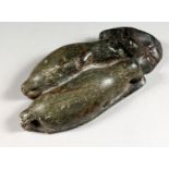 AN INUIT CARVED HARDSTONE GROUP OF TWO SLEEPING SEALS. 8.5ins long.
