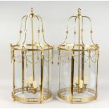 A GOOD LARGE PAIR OF GEORGIAN STYLE BRASS CIRCULAR HALL LANTERNS. 33ins high.