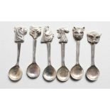 A SET OF SIX SILVER ANIMAL HEAD SPOONS.