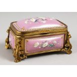 A GOOD CONTINENTAL PINK ENAMEL JEWELLERY BOX, with gilt mounts painted with flowers. 4.5ins long.