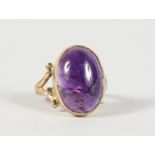 A 9CT GOLD AND LARGE AMETHYST RING.