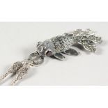 AN ARTICULATED FISH on a silver and marcasite chain.