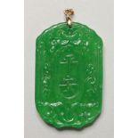 A CHINESE CARVED APPLE GREEN JADE PENDANT. 2.25ins high.