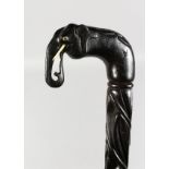 A CEYLONESE CARVED WALKING STICK, with elephant handle with tusks. 35ins long.