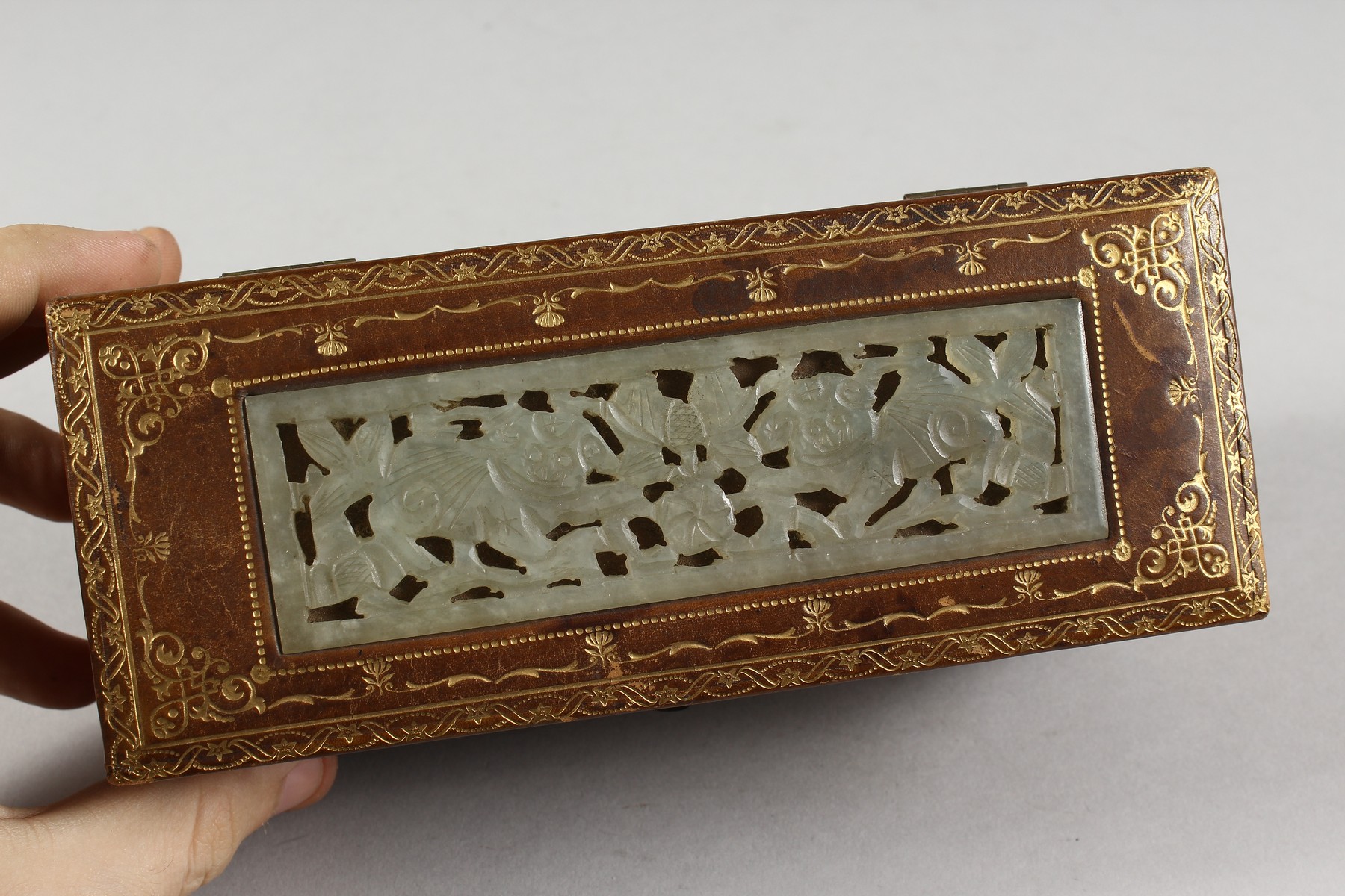 A GILT TOOLED LEATHER BOX INSET WITH A PIERCED JADE PANEL. 7ins long. - Image 2 of 3