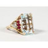 AN IMPRESSIVE LARGE AQUAMARINE, DIAMOND AND RUBY MOUNTED GOLD RING.