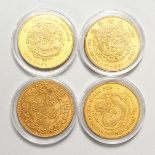 FOUR CHINESE GILT METAL COINS. 1.75ins diameter.