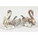 A PAIR OF SILVER MOUNTED GLASS SWAN SHAPE SALTS. 3ins long.
