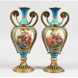 A GOOD PAIR OF 19TH CENTURY SEVRES PORCELAIN AND ORMOLU TWO HANDLED VASES, pale blue ground