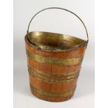 A 19TH CENTURY BRASS BOUND OVAL MAHOGANY BUCKET. 13ins high.