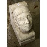 A RECONSTITUTED STONE CORBEL OF A MANS HEAD. 19ins high x 8ins wide x 14ins deep.