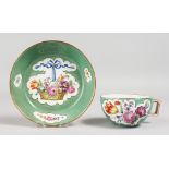 A GOOD MEISSEN GREEN GROUND CUP AND SAUCER painted with baskets of flowers. Mark in blue.
