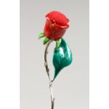 A SILVER AND ENAMEL MODEL OF A ROSE. 2.5ins long.