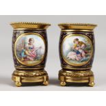 A VERY GOOD PAIR OF SEVRES RICH BLUE ORMOLU MOUNTED VASES, painted with reverse panels of figures
