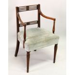 A GEORGE III MAHOGANY CARVER/DESK CHAIR, with two rows of pierced bars, reeded arms, overstuffed