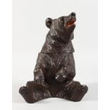 A BLACK FOREST CARVED WOOD BEAR CADDY. 8ins high.