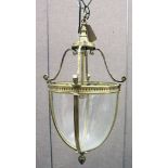 A BRASS AND GLASS HALL LANTERN, with four panels of plain curving glass. 21ins high.