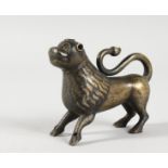 A SMALL EUROPEAN CAST BRONZE MODEL OF A STANDING LION, Possibly 12th Century, with traces of gilding