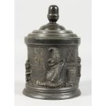 AN UNUSUAL VICTORIAN PEWTER TOBACCO BOX, with Mr Punch decoration. 6.5ins high.
