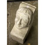 A RECONSTITUTED STONE CORBEL OF A MANS HEAD. 21ins high x 8ins wide x 15ins deep.