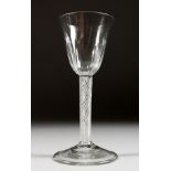 A LARGE GEORGIAN WINE GLASS with semi fluted bowl and air twist stem. 6.25ins high.