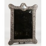 A GOOD UPRIGHT EASEL MIRROR, pierced silver on velvet. 19ins high x 14ins wide. Chester 1902.