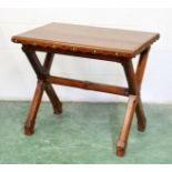 AN ARTS AND CRAFTS PITCH PINE TABLE, rectangular top, "X" framed support inset with coloured