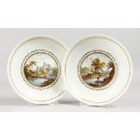 A PAIR OF 18TH CENTURY DERBY PLATES, painted with scenes entitled 'River Trent' and 'Italy', paper
