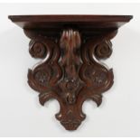 A CARVED OAK WALL BRACKET. 14.5ins high x 13.5ins wide x 6ins deep.