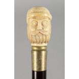 A WALKING STICK, the bone handle carved as a bust of a man. 35.5ins long.