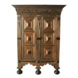 A GOOD 17TH CENTURY FLEMISH OAK TWO DOOR CUPBOARD, with moulded oak leaf carved cornice, a pair of