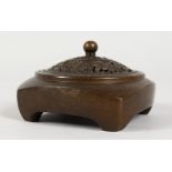 A SMALL CHINESE BRONZE CENSER WITH PIERCED LID. 3ins wide.