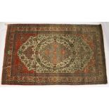 A GOOD PERSIAN RUG, EARLY 20TH CENTURY, beige ground, with floral decoration, signed. 7ft 6ins x 4ft
